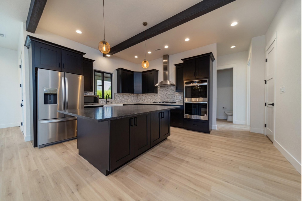 3642 White Lily Ave kitchen with dark cabinetry
